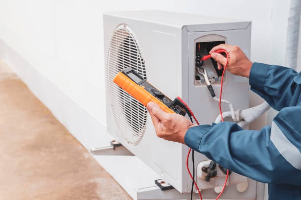 air-conditioner-technician-repairing-central-air-conditioning-system-with-outdoor-tools